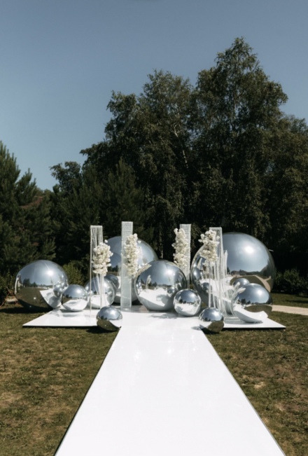 Stunning Mercury Balls displayed at a lavish event in the Maryland and DC area, expertly planned by Stormy Brooks. The decor enhances the festive atmosphere, featuring engaging activities and live performances. Guests enjoy an elegant evening under ambient lighting, celebrating a beautifully curated experience.